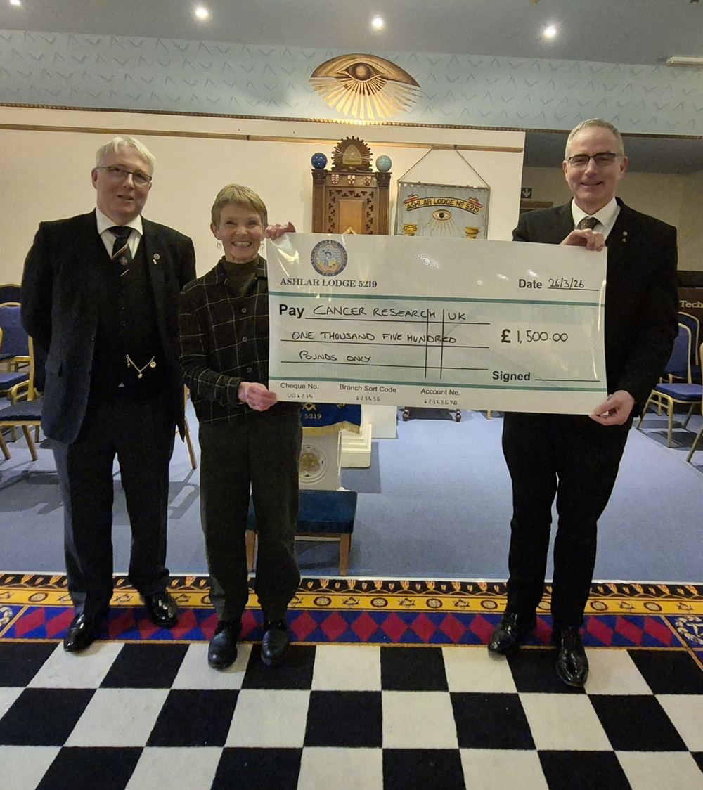 Members of Ashlar Lodge presenting a cheque for £1,500 to Cancer Research UK