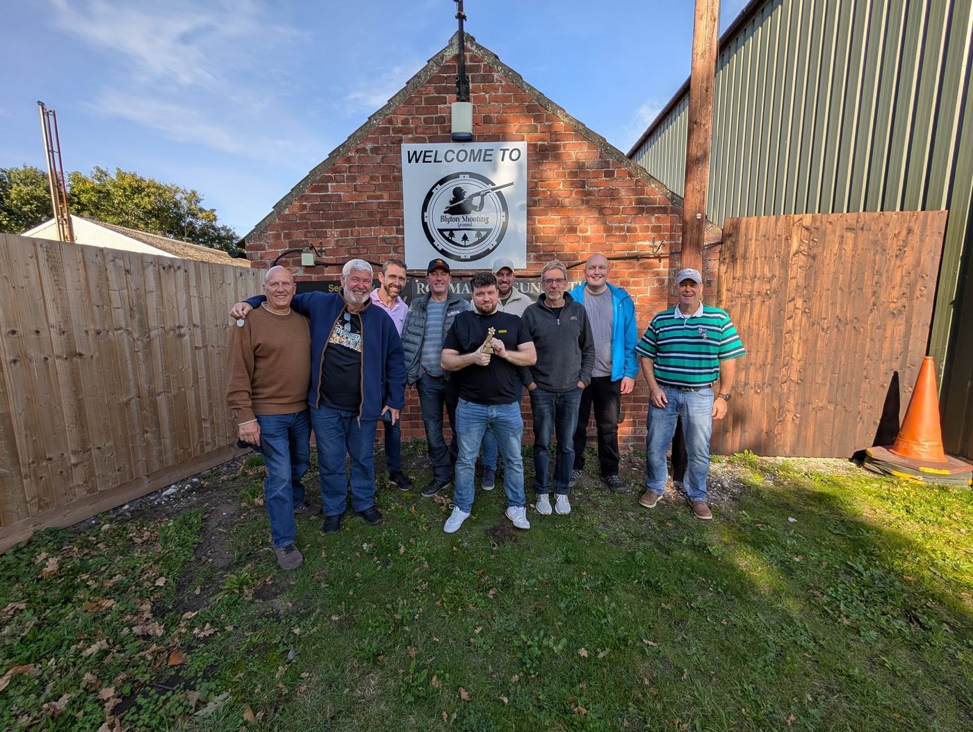 Members at Blyton Shooting Ground, one holding a trophy