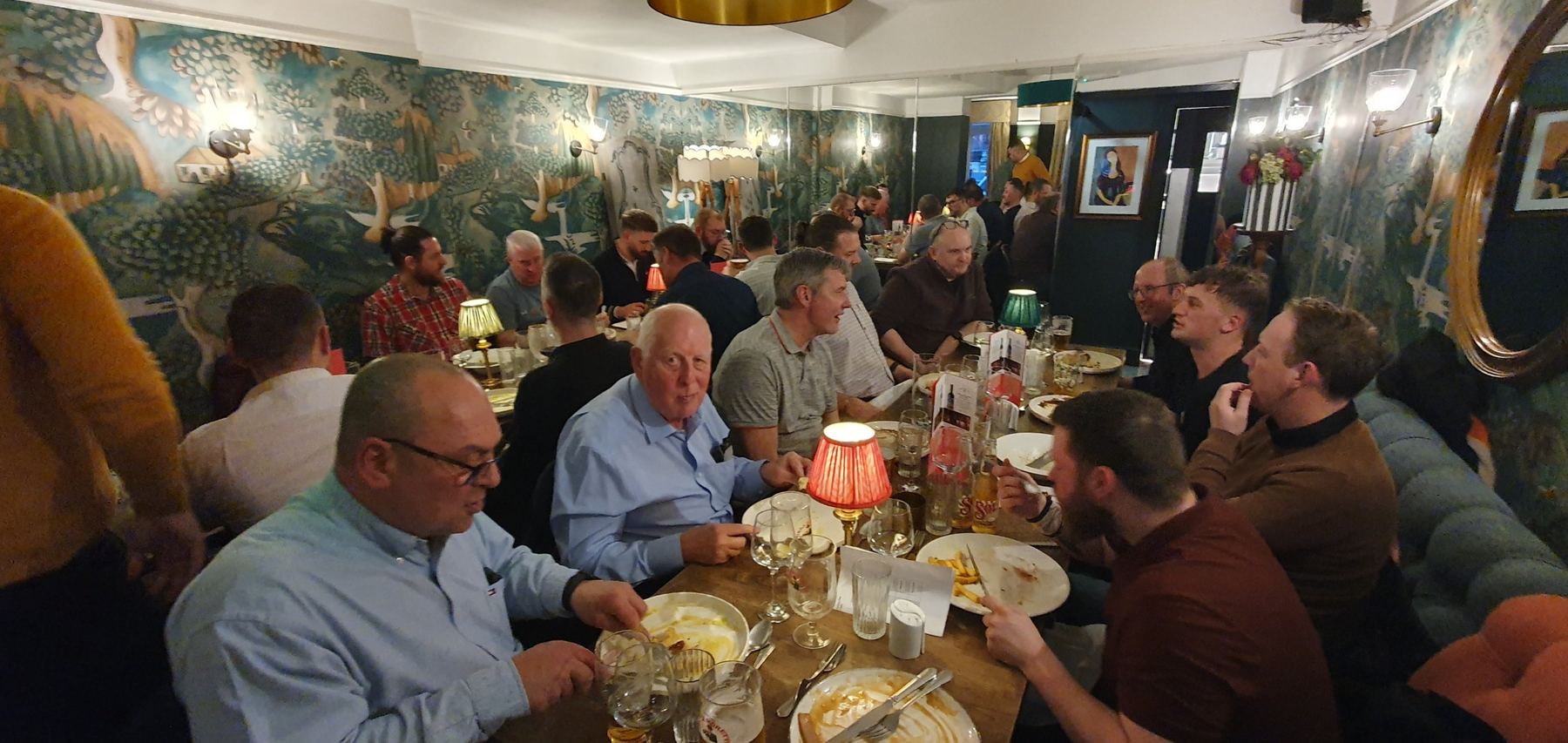 A long table of members enjoying a meal out together