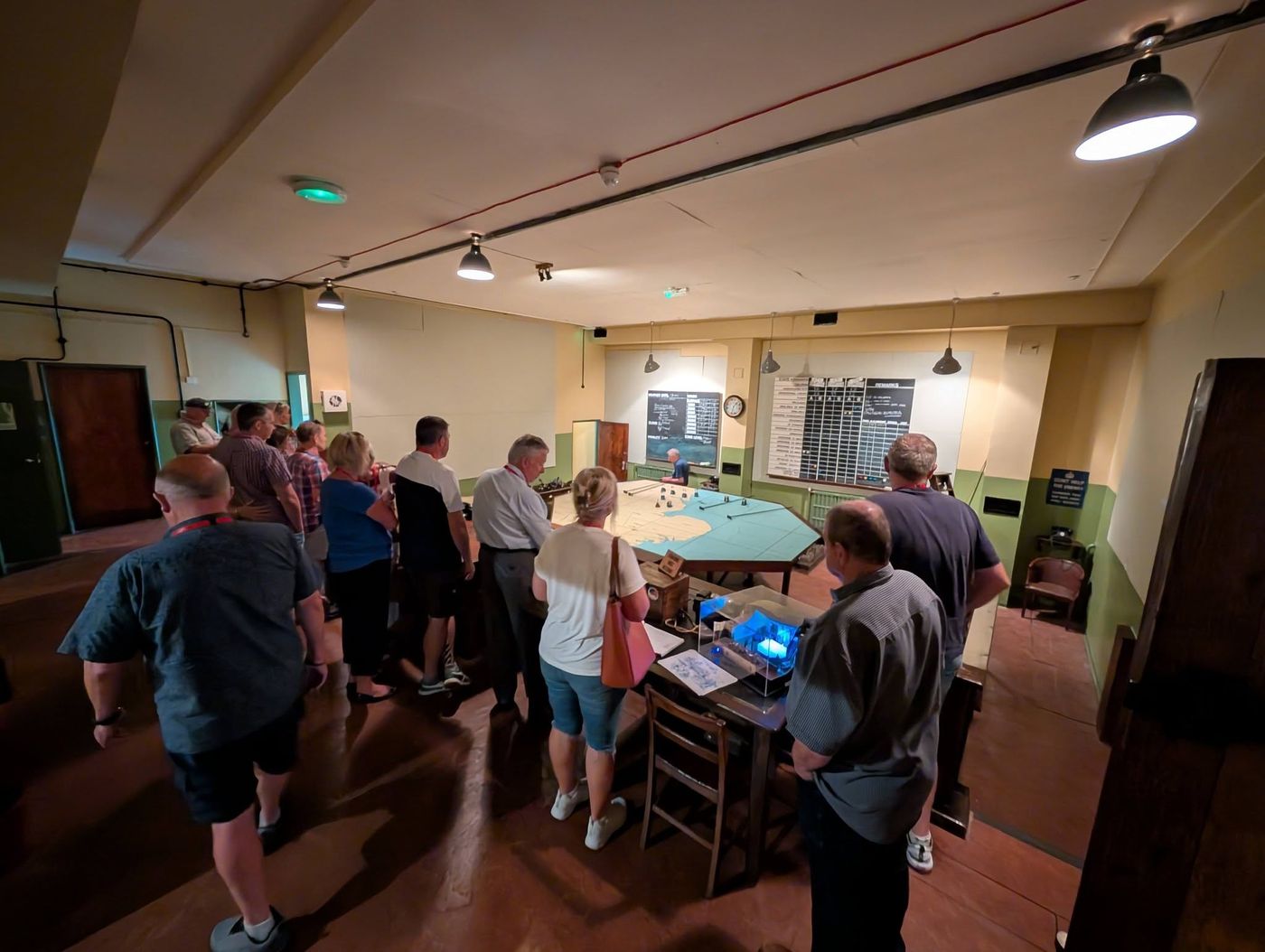 Members gathered around the plotting table in the Sector Operations Room at RAF Digby